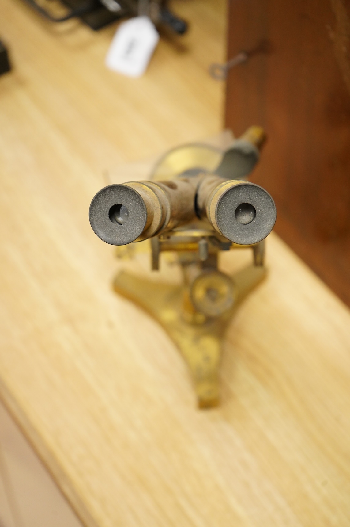 A late 19th century brass compound binocular microscope, by R. & J. Beck, London, number 13654, mahogany cased, together with accessories, including a pair of eye pieces and three objectives. Instrument height 39cm